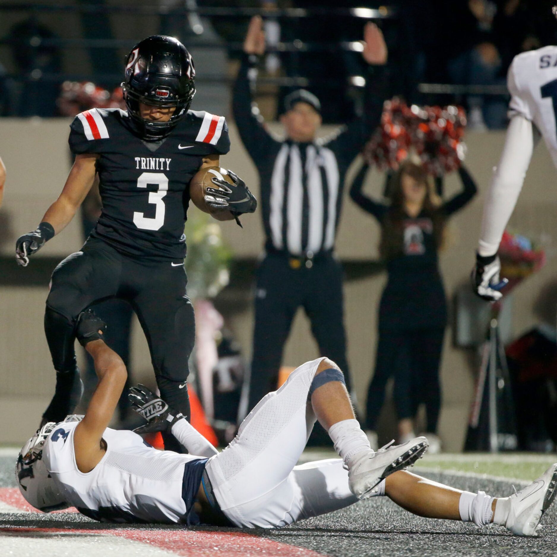 Euless Trinity's Zechariah Moore (3) scores a touchdown as Richland's  C.J. Baskerville (3)...