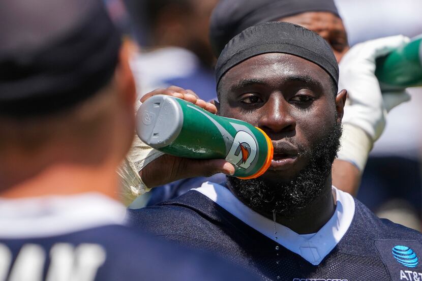 Dallas Cowboys defensive tackle Neville Gallimore (96) gets a drink of water during a...