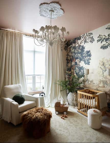 Nursery in soothing neutral tones, with nature-inspired wallpaper, cram curtains and a cream...