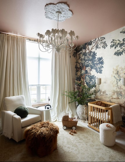 Nursery in soothing neutral tones, with nature-inspired wallpaper, cram curtains and a cream...