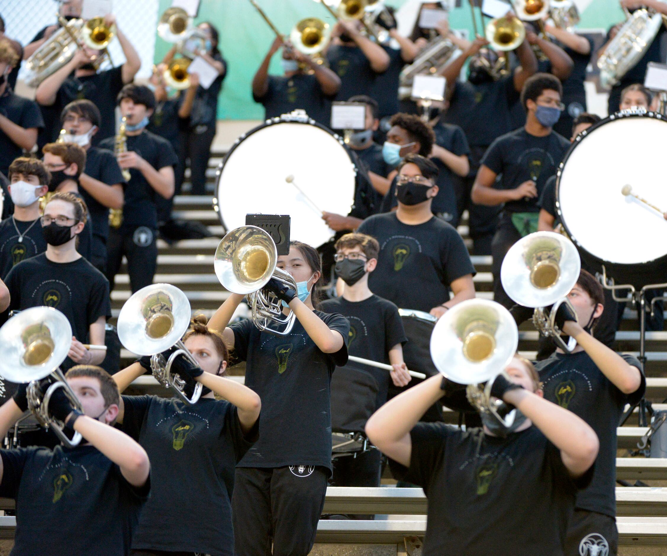 The Richardson Berkner band performs before a high school football game between Woodrow...