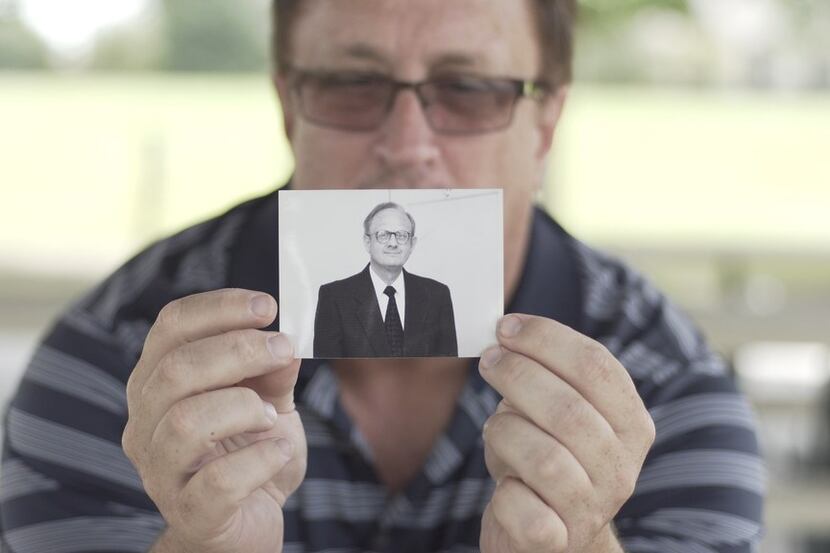 Guy Moore, son of the Rev. Charles Moore, holds a photo of his father in the PBS Independent...