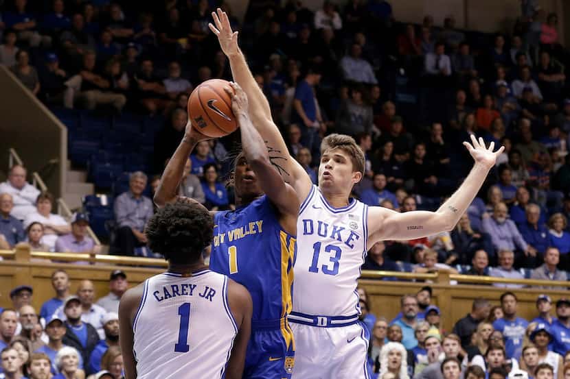 Duke forward Joey Baker (13) and center Vernon Carey Jr. (1) guard Fort Valley State guard...