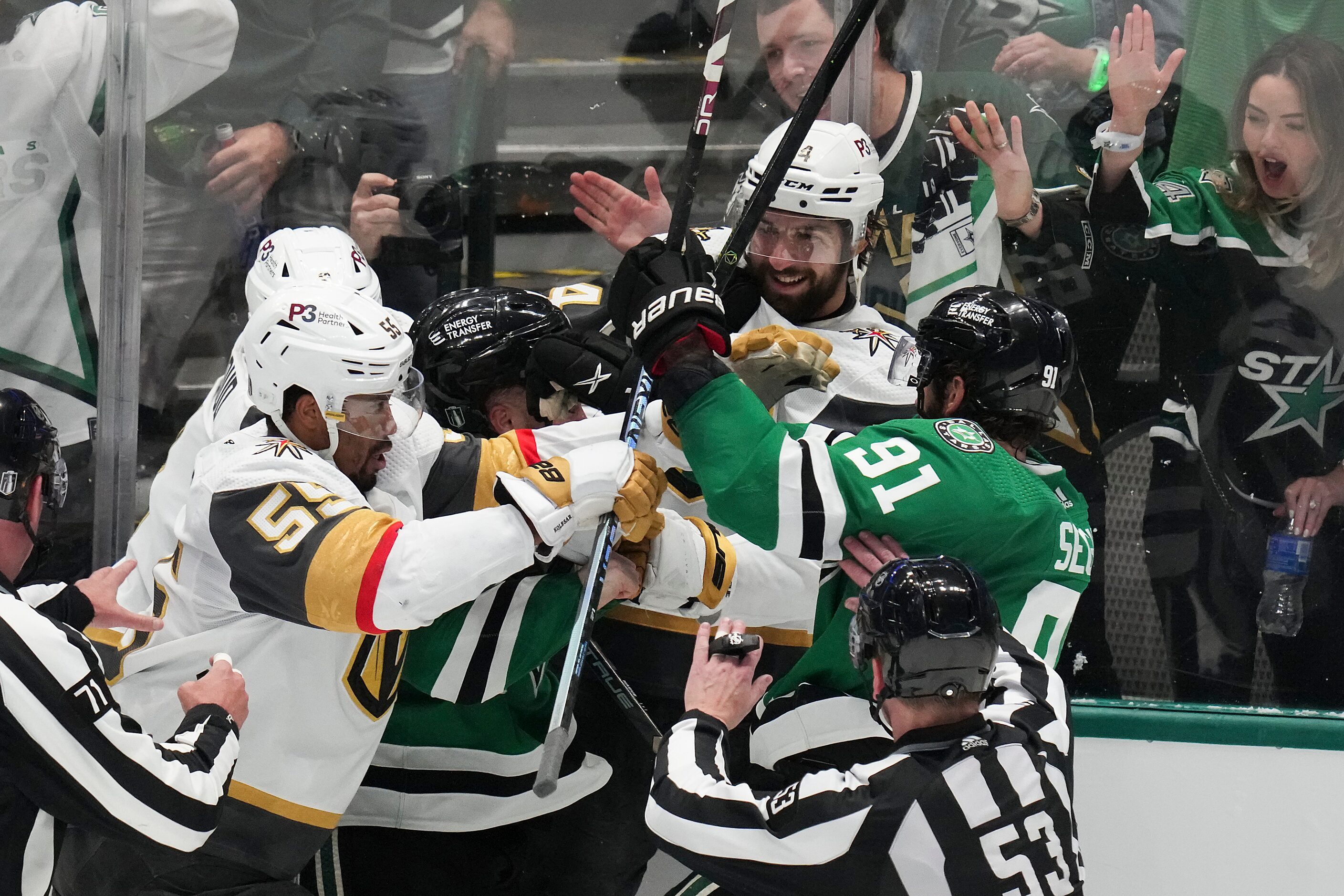 Players and officials try to separate Vegas Golden Knights defenseman Nicolas Hague (14)...