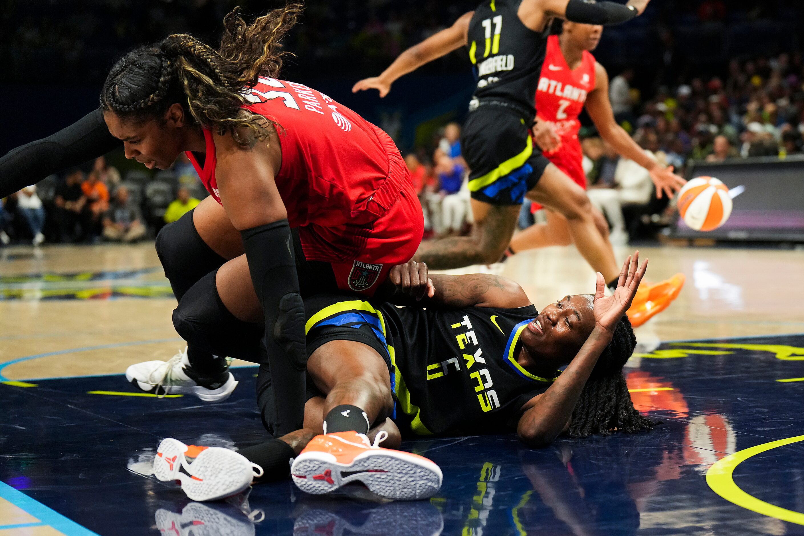 Dallas Wings forward Natasha Howard (6) gets tangled with Atlanta Dream forward Cheyenne...