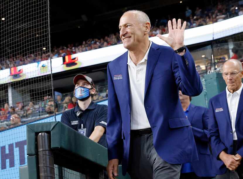 Texas Rangers Baseball Hall of Fame member Eric Nadel waves to the crowd as he's introduced...