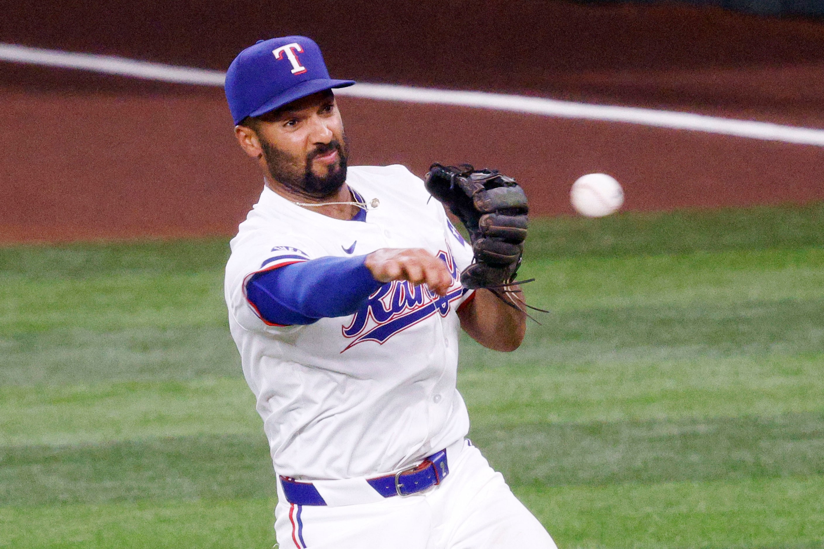 Texas Rangers second base Marcus Semien (2) throws to the first base to make New York...