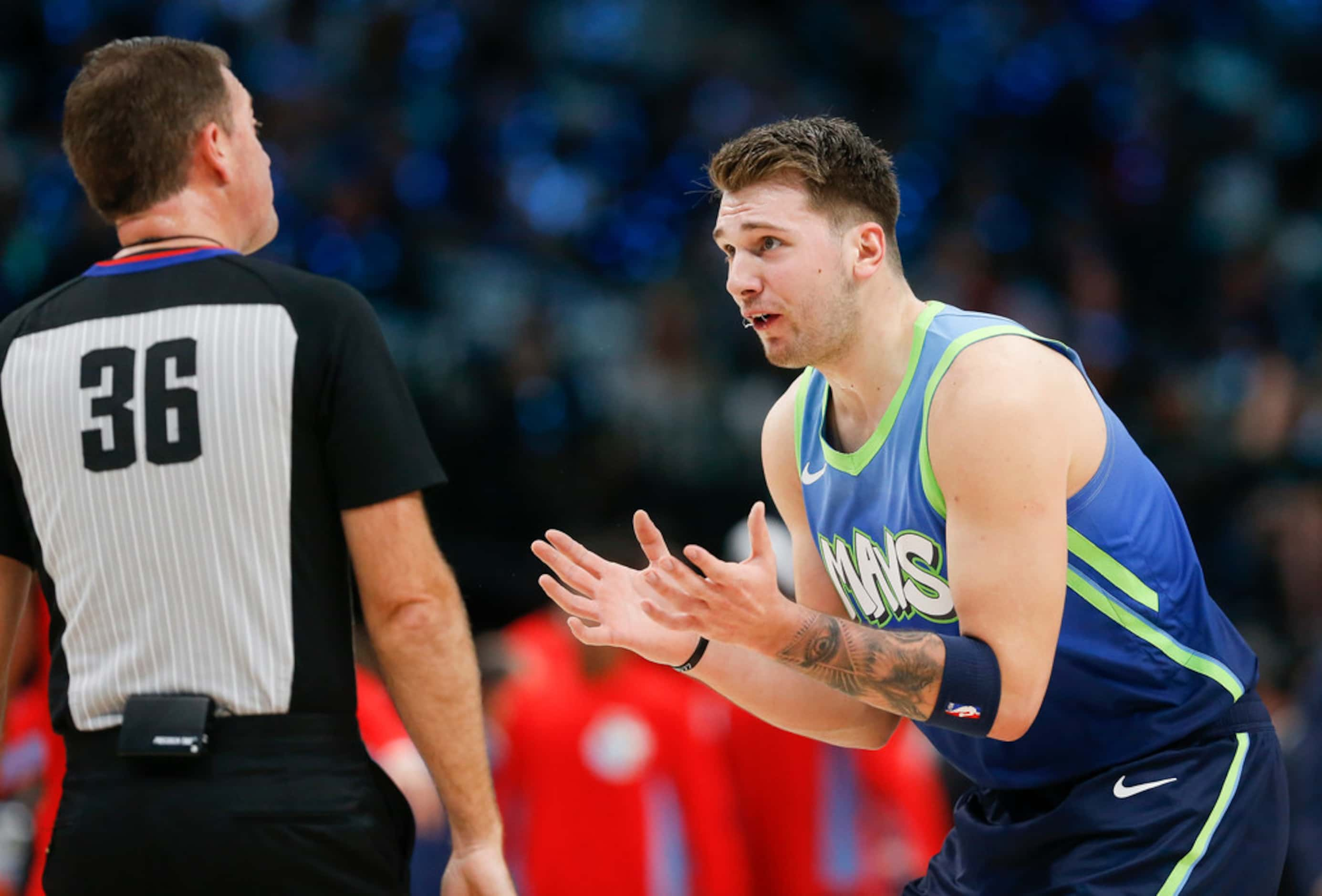 Dallas Mavericks forward Luka Doncic (77) disputes a call by referee David Jones (36) during...