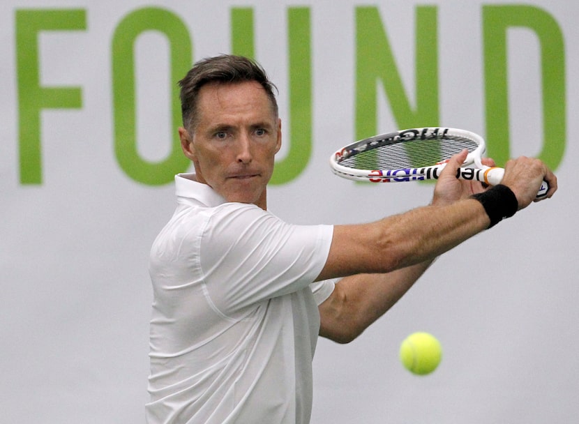 Former Dallas Mavericks point guard Steve Nash exhibits great focus as he returns a volley...