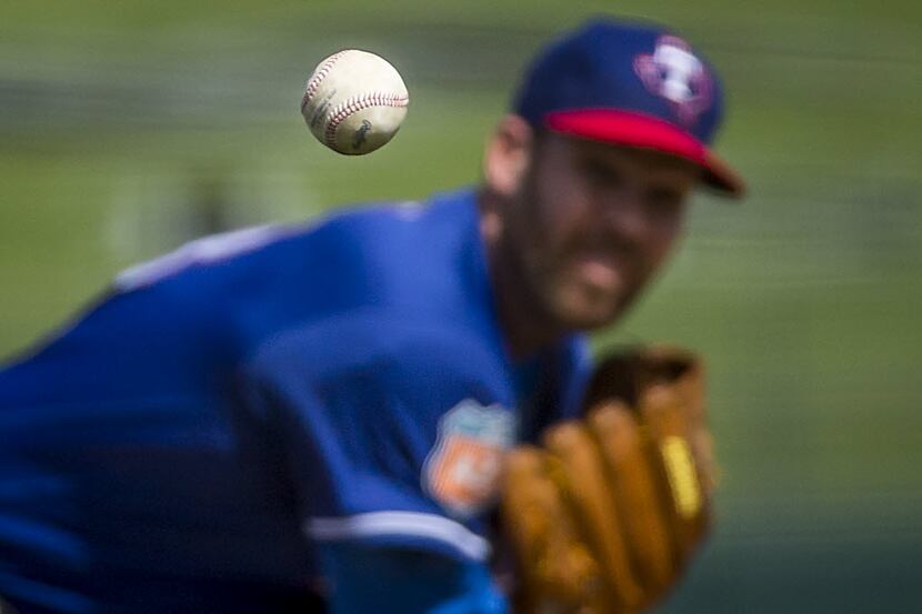 Texas Rangers pitcher Colby Lewis pitches during the first inning against the Kansas City...