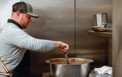 Owner Evan Meagher stirs a pot of gumbo on Fat Tuesday in the kitchen of Evan's Meat Market...