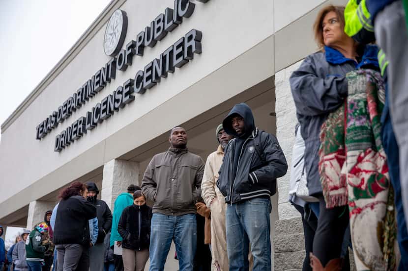 People line up at outside of the entrance at the Texas Department of Public Safety Driver...