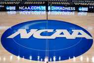 In this March 18, 2015, file photo, the NCAA logo is displayed at center court at The Consol...