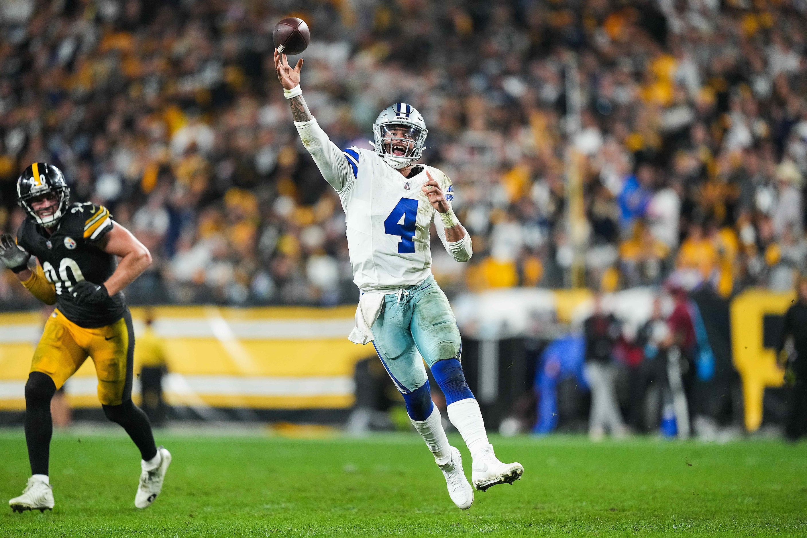 Dallas Cowboys quarterback Dak Prescott (4) throws a touchdown pass to running back Rico...