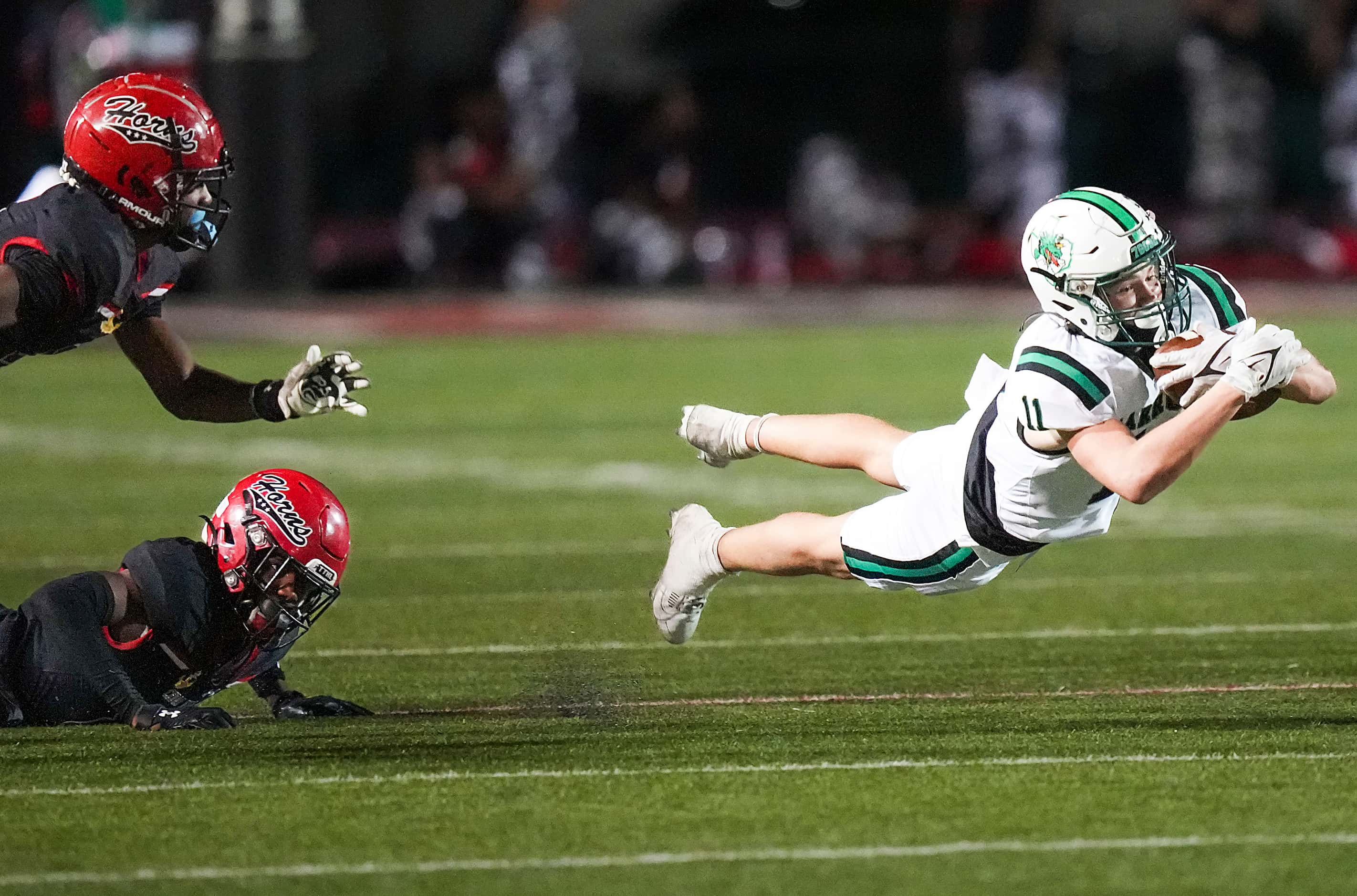Southlake Carroll wide receiver Brock Boyd (11) dives for extra yardage past Cedar Hill...