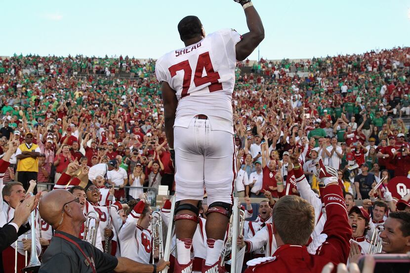 SOUTH BEND, IN - SEPTEMBER 28: Adam Shead #74 of the Oklahoma Sooners conducts the band...