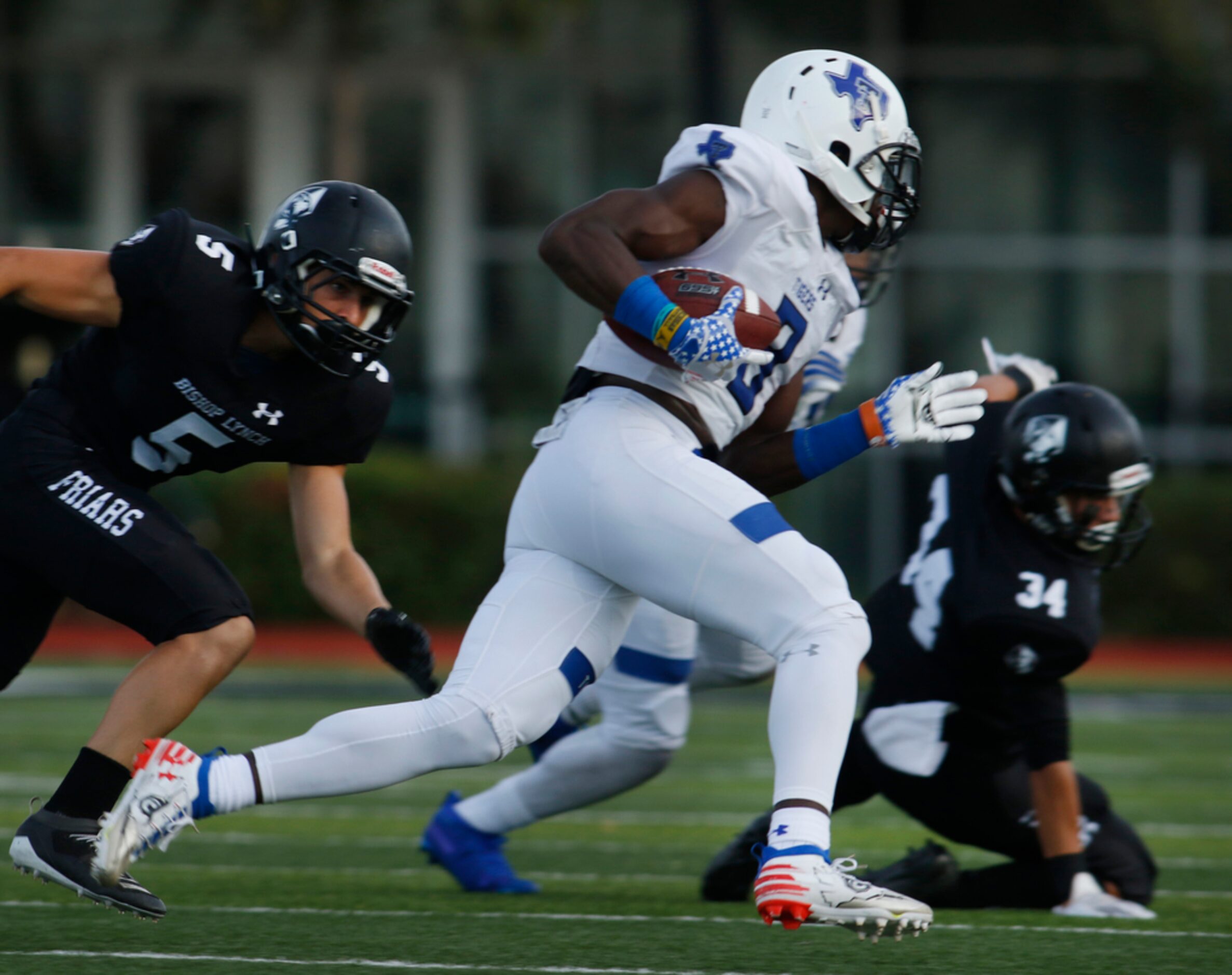 Trinity Christian-Cedar Hill receiver Marquez Buford (8) changes field for extra yardage as...