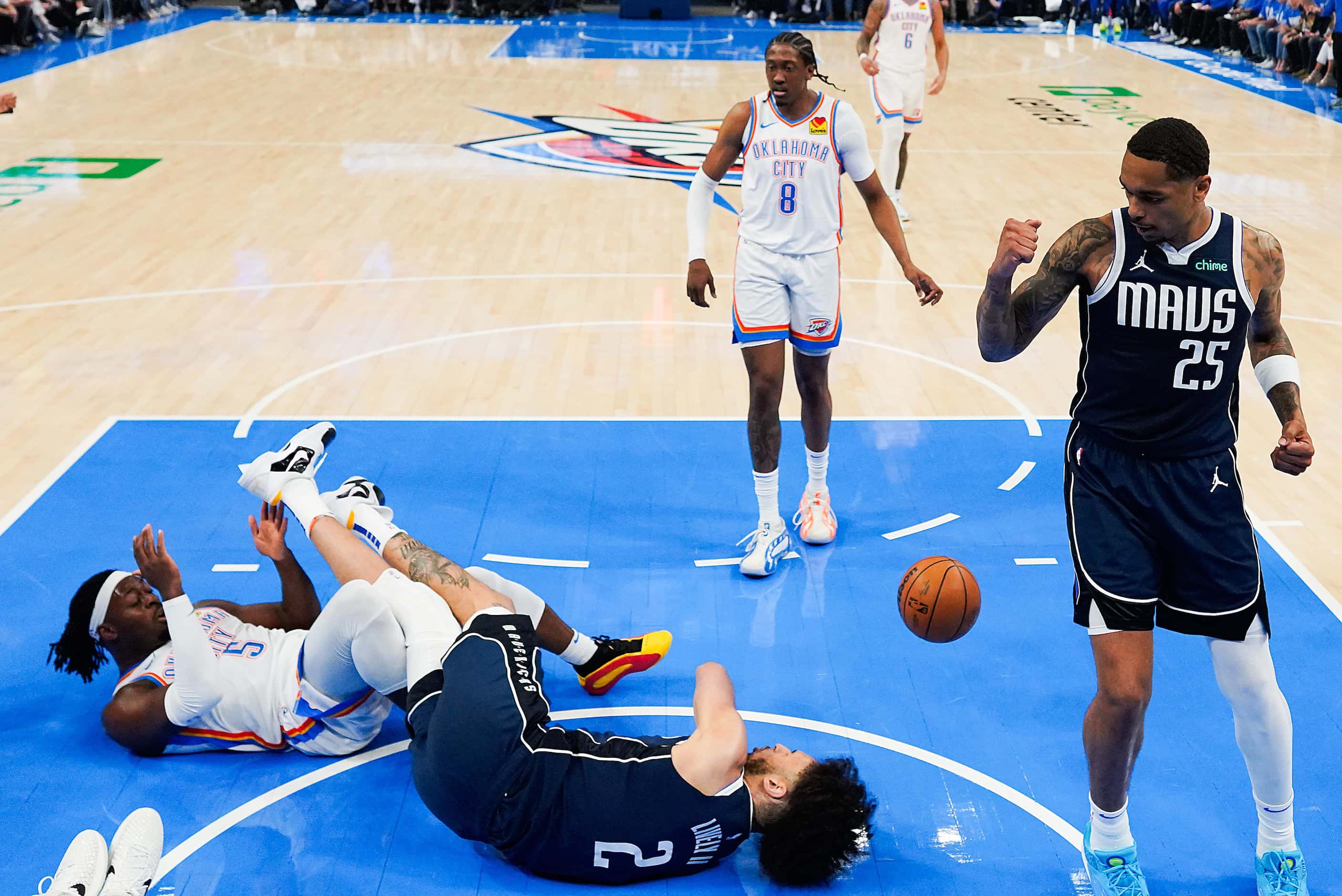 Dallas Mavericks center Dereck Lively II (2) tumbles to the floor after a collision with...