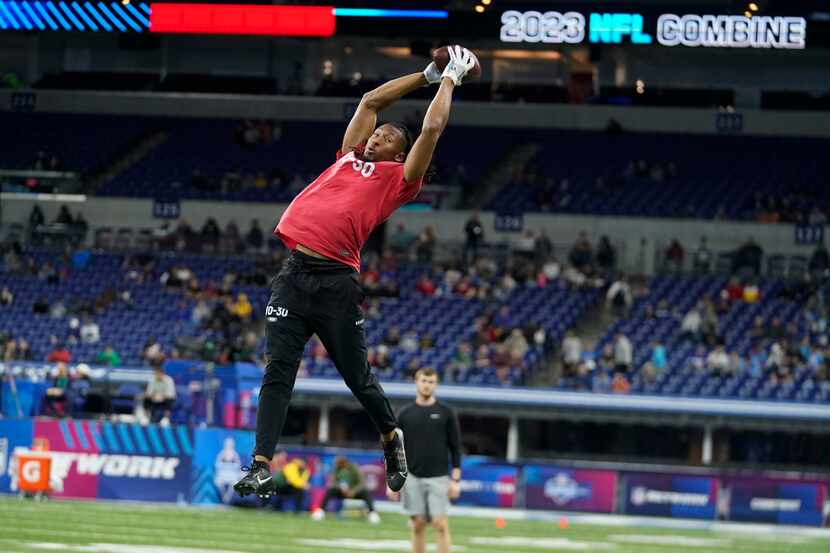 TCU wide receiver Quentin Johnston runs a drill at the NFL football scouting combine in...