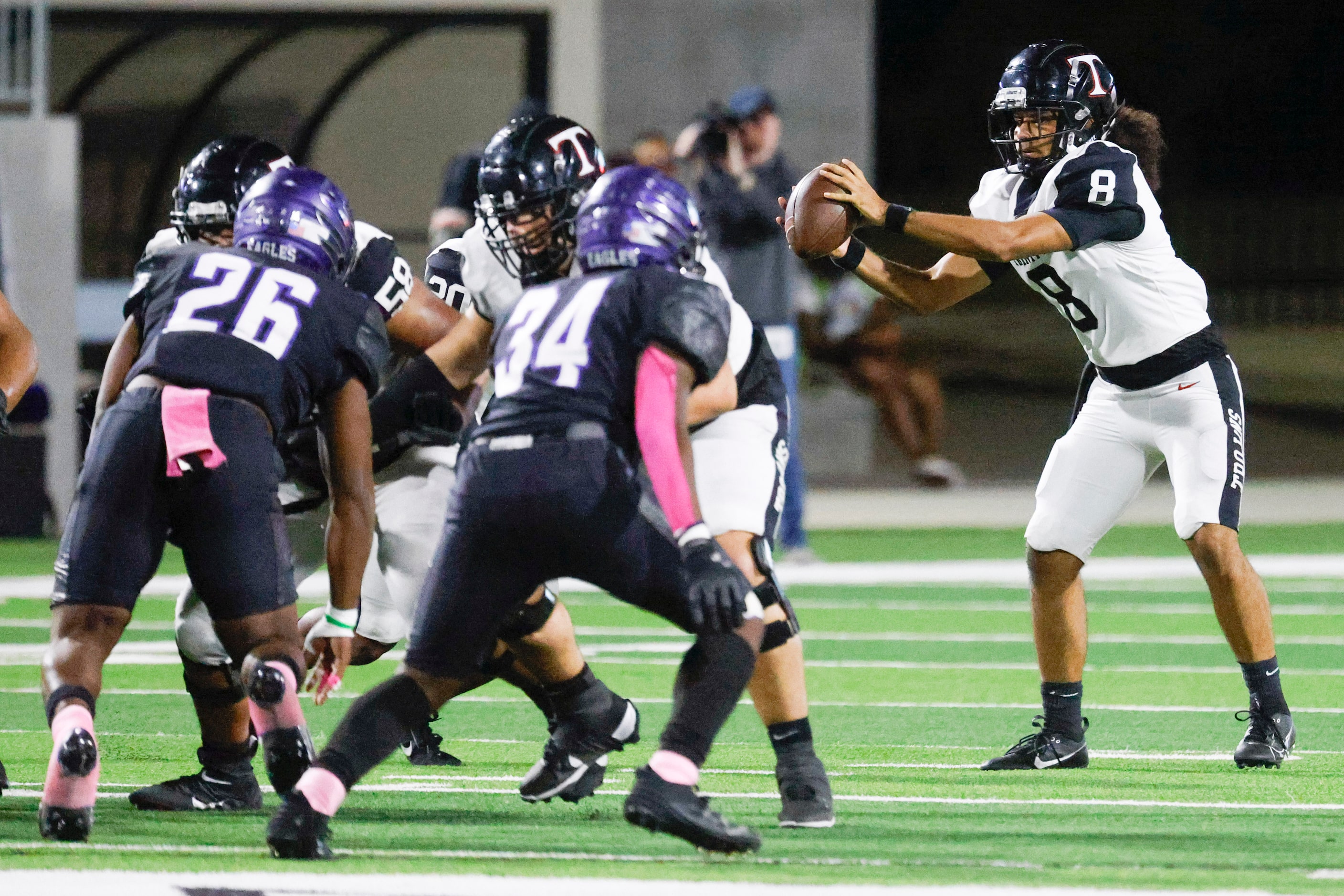 Trinity high QB TJ Tupou receives the ball to throw against Crowley High during the first...