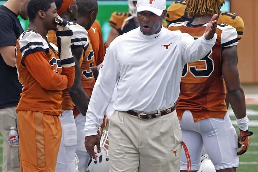 Texas coach Charlie Strong gestures during the first quarter of the NCAA college football...