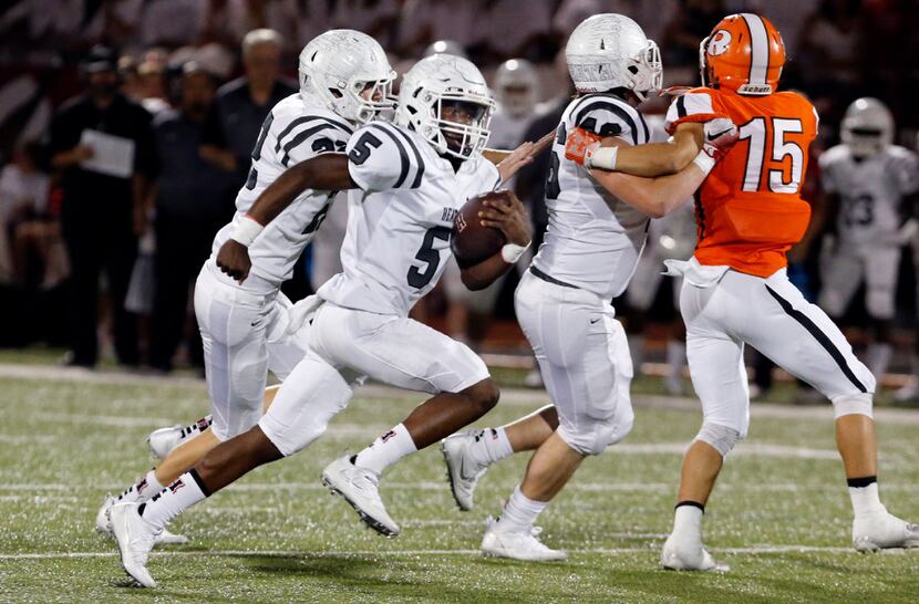 Rockwall-Heath's Tyrus Fort (5) scampers for a touchdown in a 34-27 win against Rockwall in...