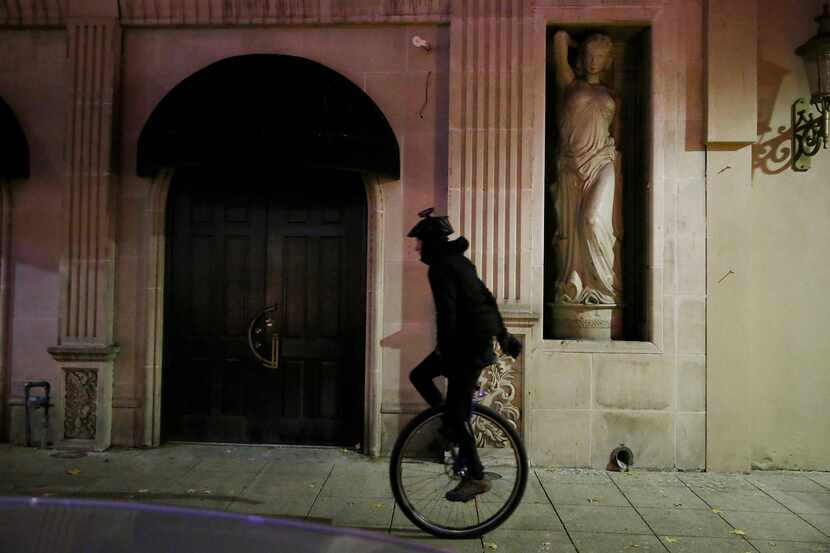A unicyclist rides near 1400 Main Street in downtown Dallas on Sunday night. 