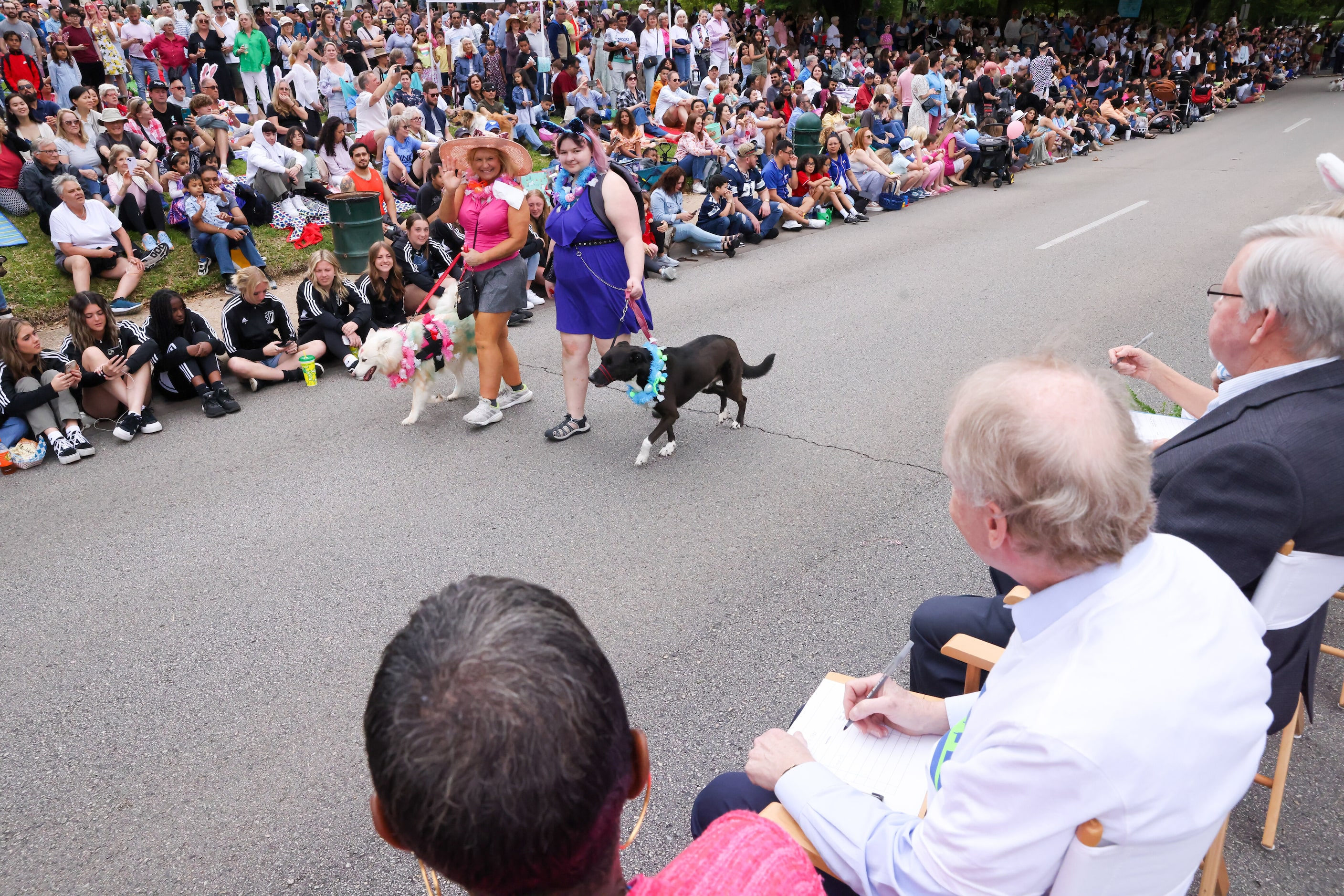 Pooch Parade contestants turn and wave to the judges as they move down Turtle Creek...