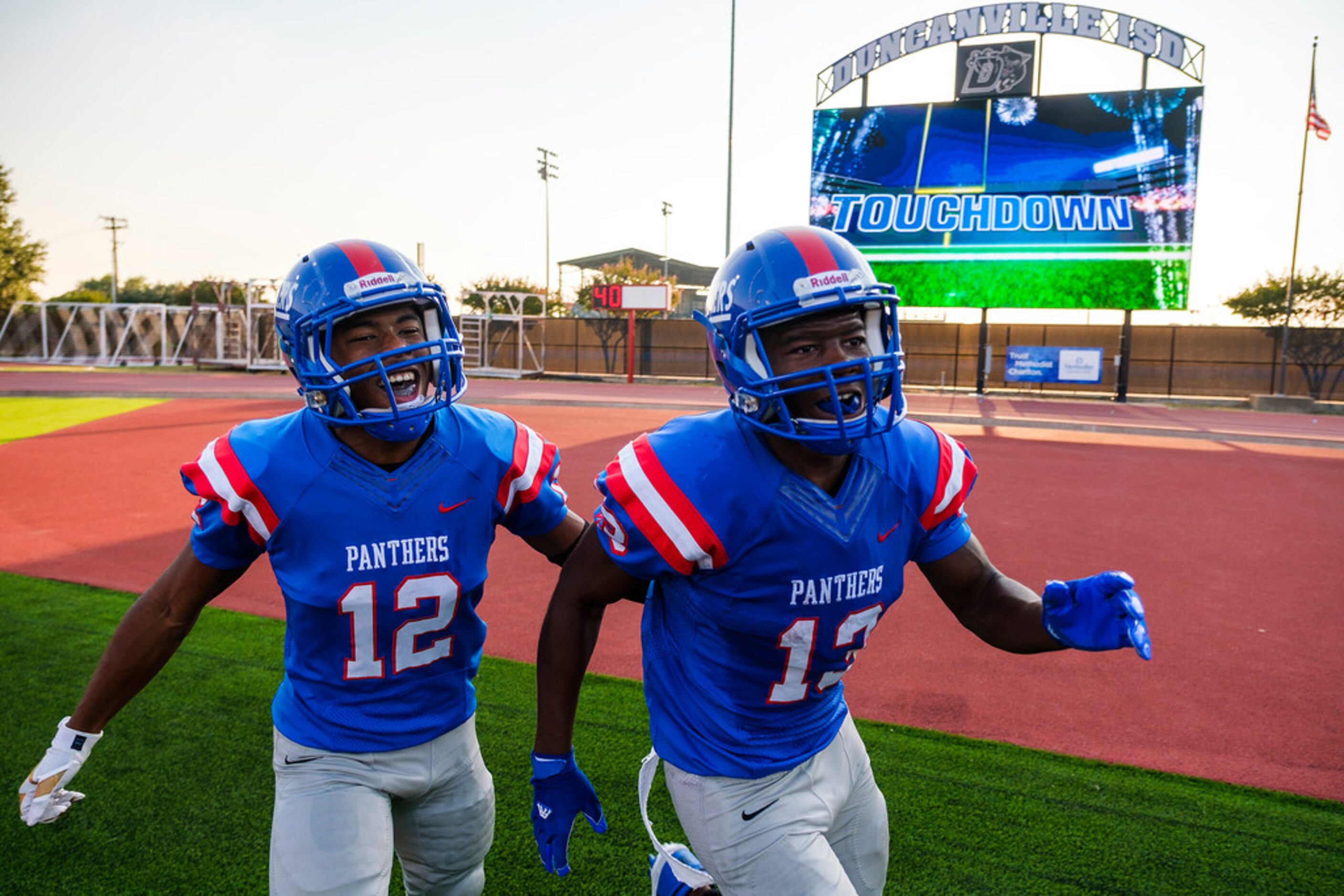 Duncanville wide receiver Roderick Daniels (13) celebrates with running back Suavevion...