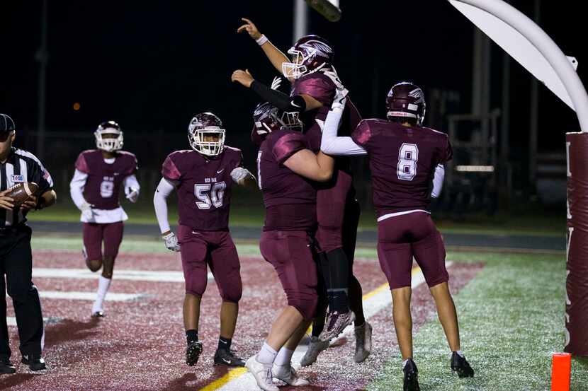 Red Oak Hawks quarterback Chris Bugg (12) celebrates a touchdown with teammates during the...