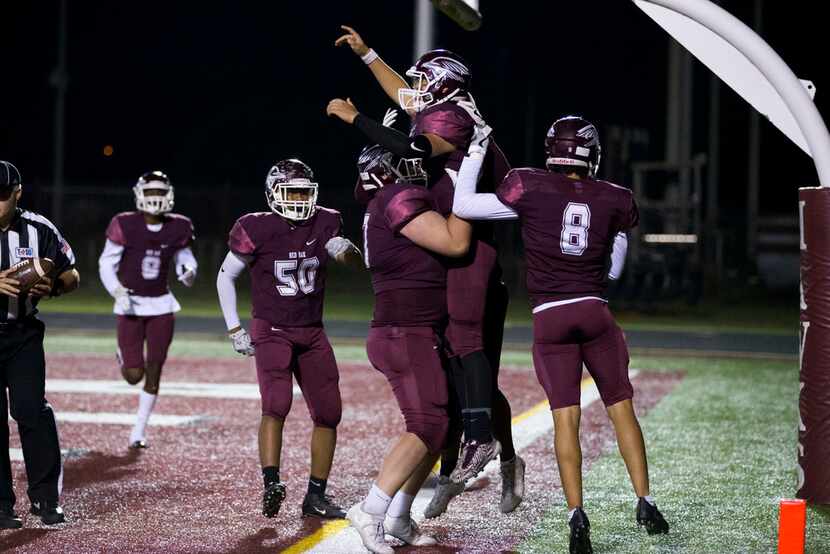 Red Oak Hawks quarterback Chris Bugg (12) celebrates a touchdown with teammates during the...