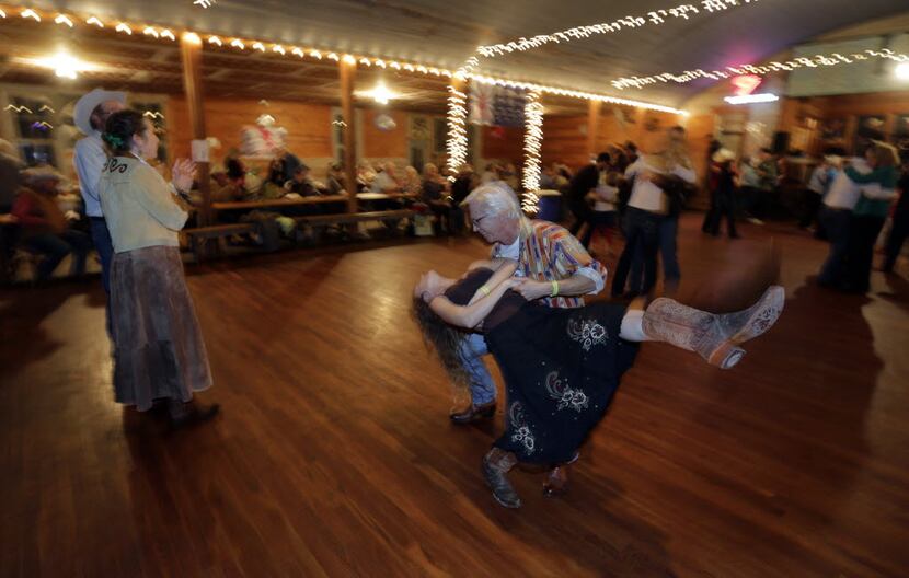 In this Dec. 6, 2014, photo, visitors dance to live music at Twin Sisters Dance Hall in...