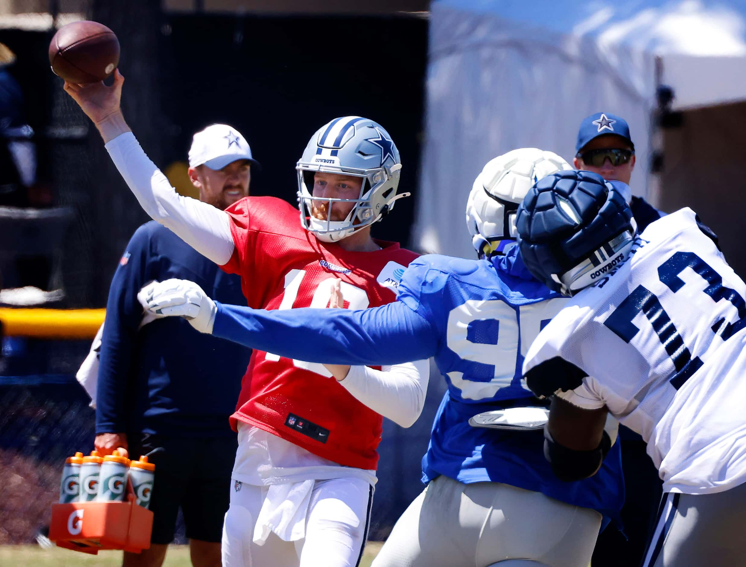 Dallas Cowboys quarterback Cooper Rush (10) fires a pass downfield against a rushing Los...