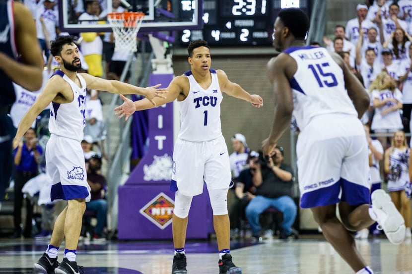 TCU Horned Frogs guard Desmond Bane (1) gets a high-five from guard Alex Robinson (25) after...