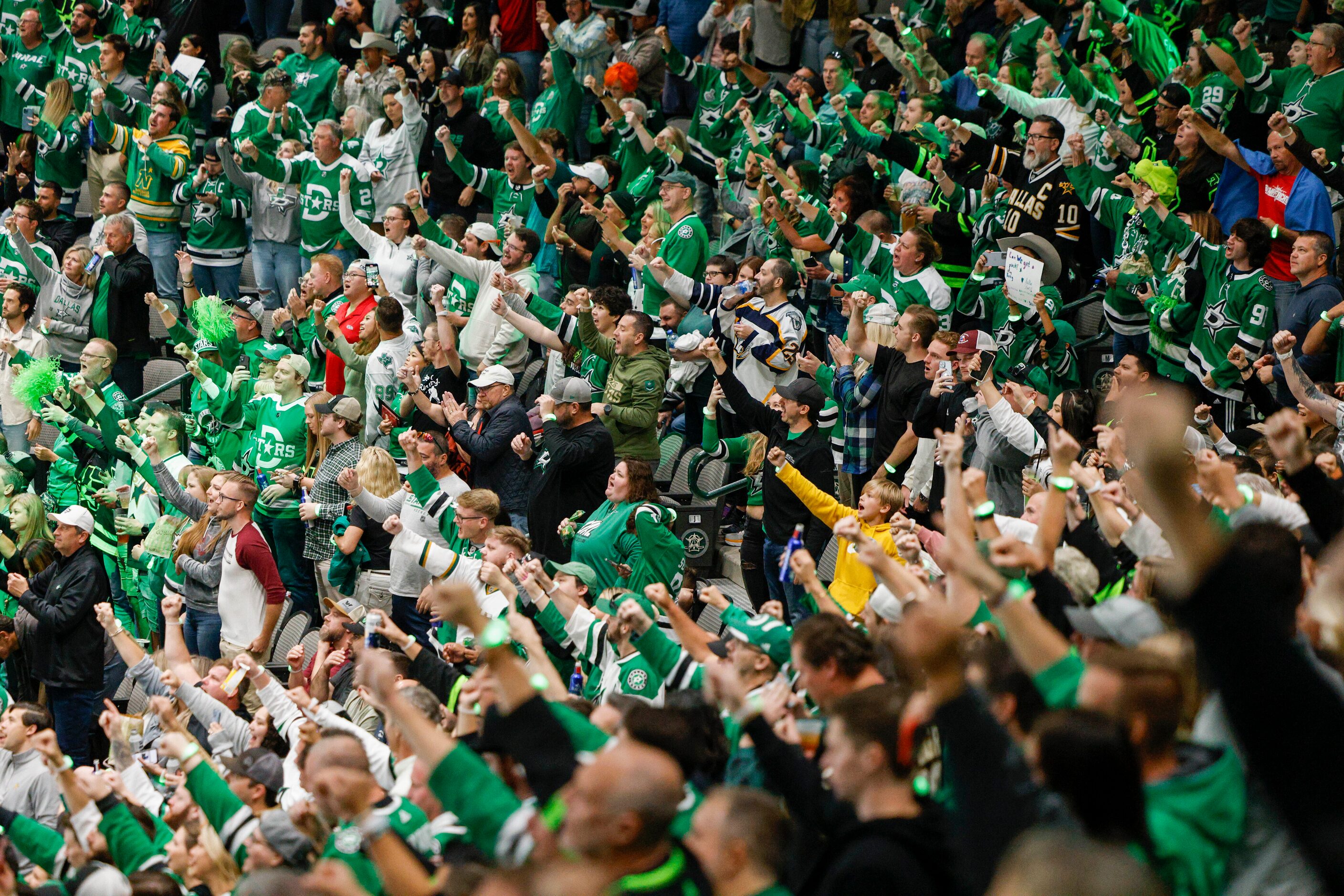 Dallas Stars fans celebrate a goal during the second period of the home opener against the...