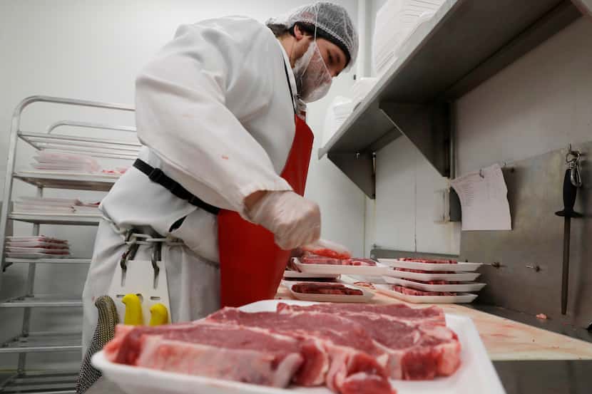 Joe V's Smart Shop meat cutter Blake Lawrence packages steaks at the store in Pasadena.