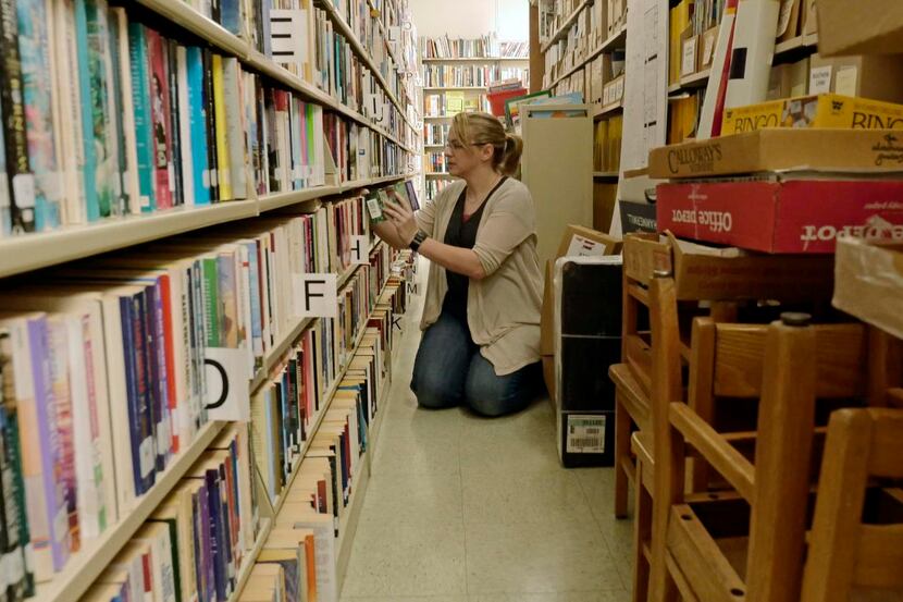 A library clerk shelves books in this file photo.