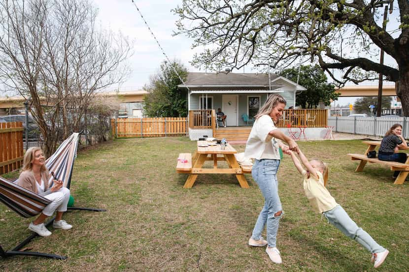 Willow Faye Chapman swings from her mother, Jillian Chapman, as her grandmother, Sandra...