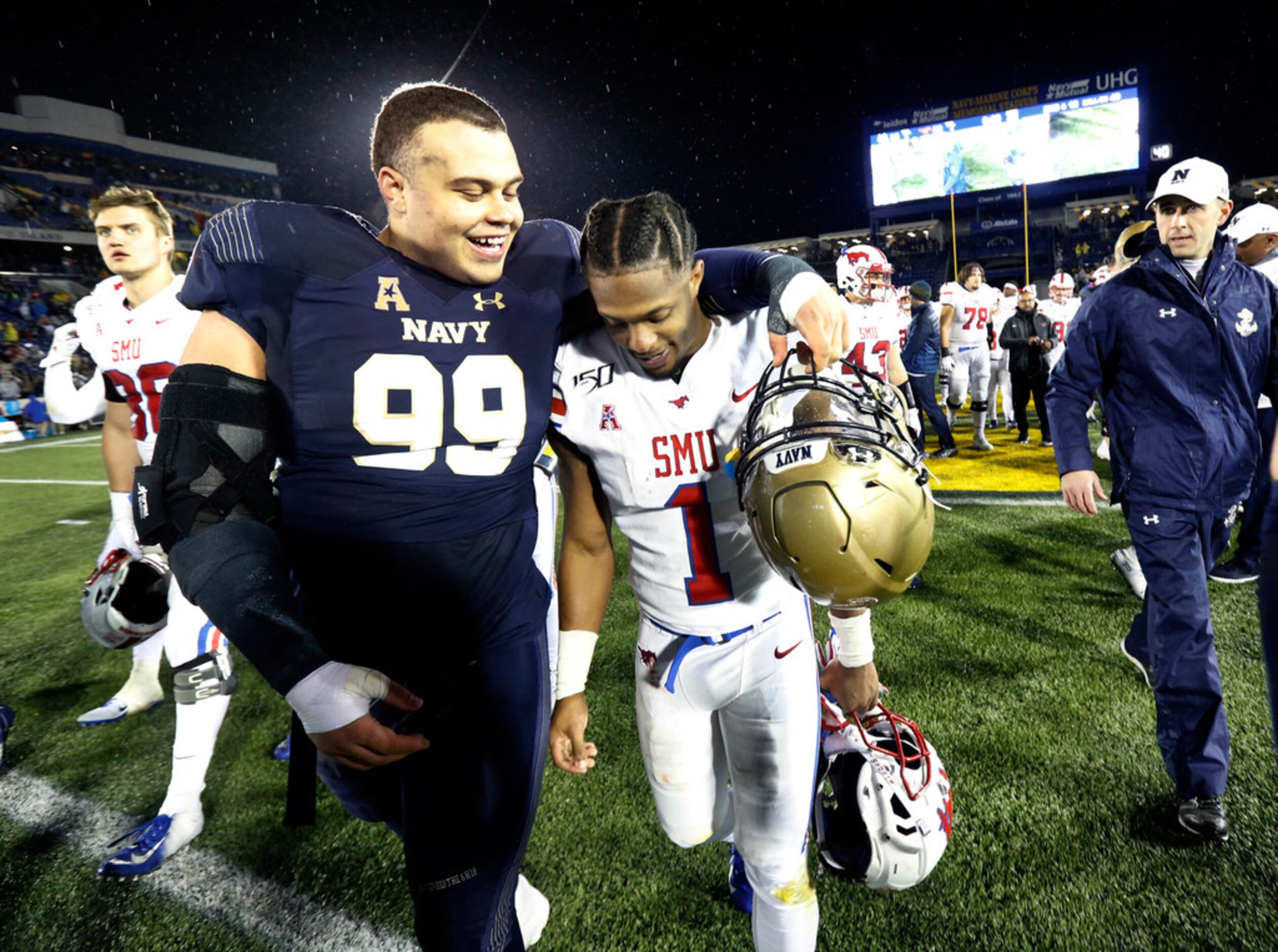 Navy Midshipmen defensive lineman Jackson Pittman (99) walks arm-in-arm with Southern...