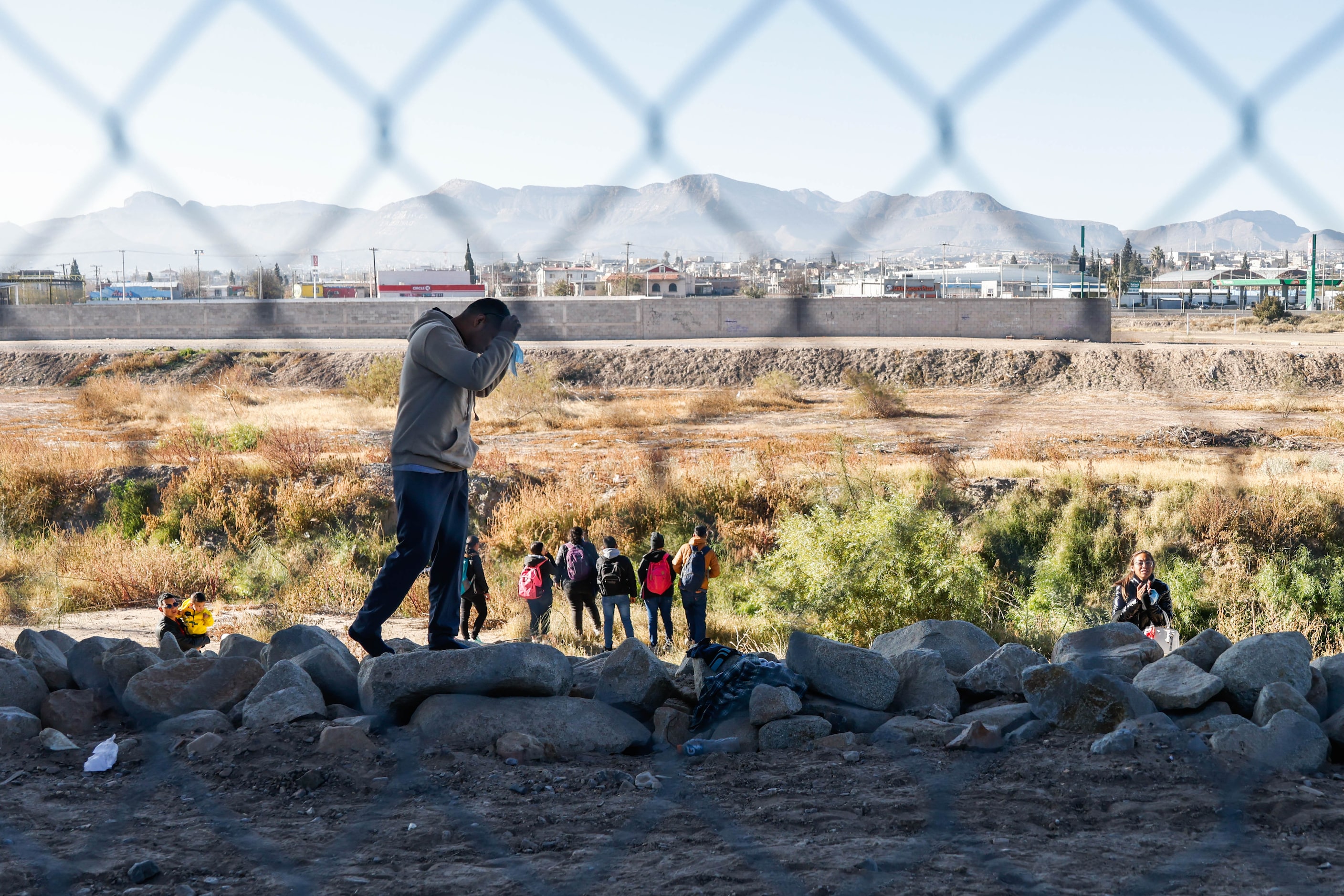 A migrant from Peru tries to cross into the United States with a group of other migrants...