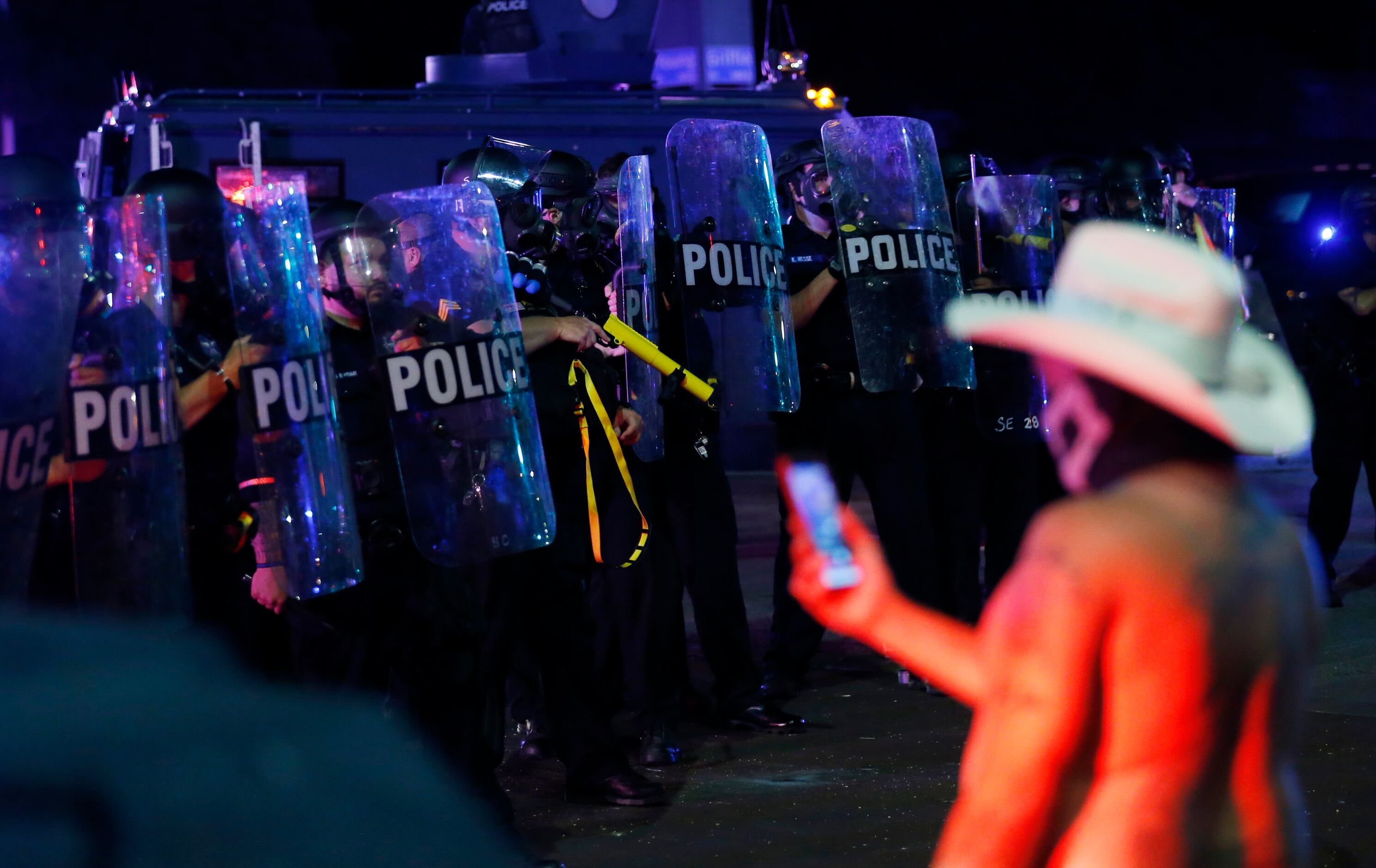 Dallas police work on controlling the protesters along the intersection of Young Street and...
