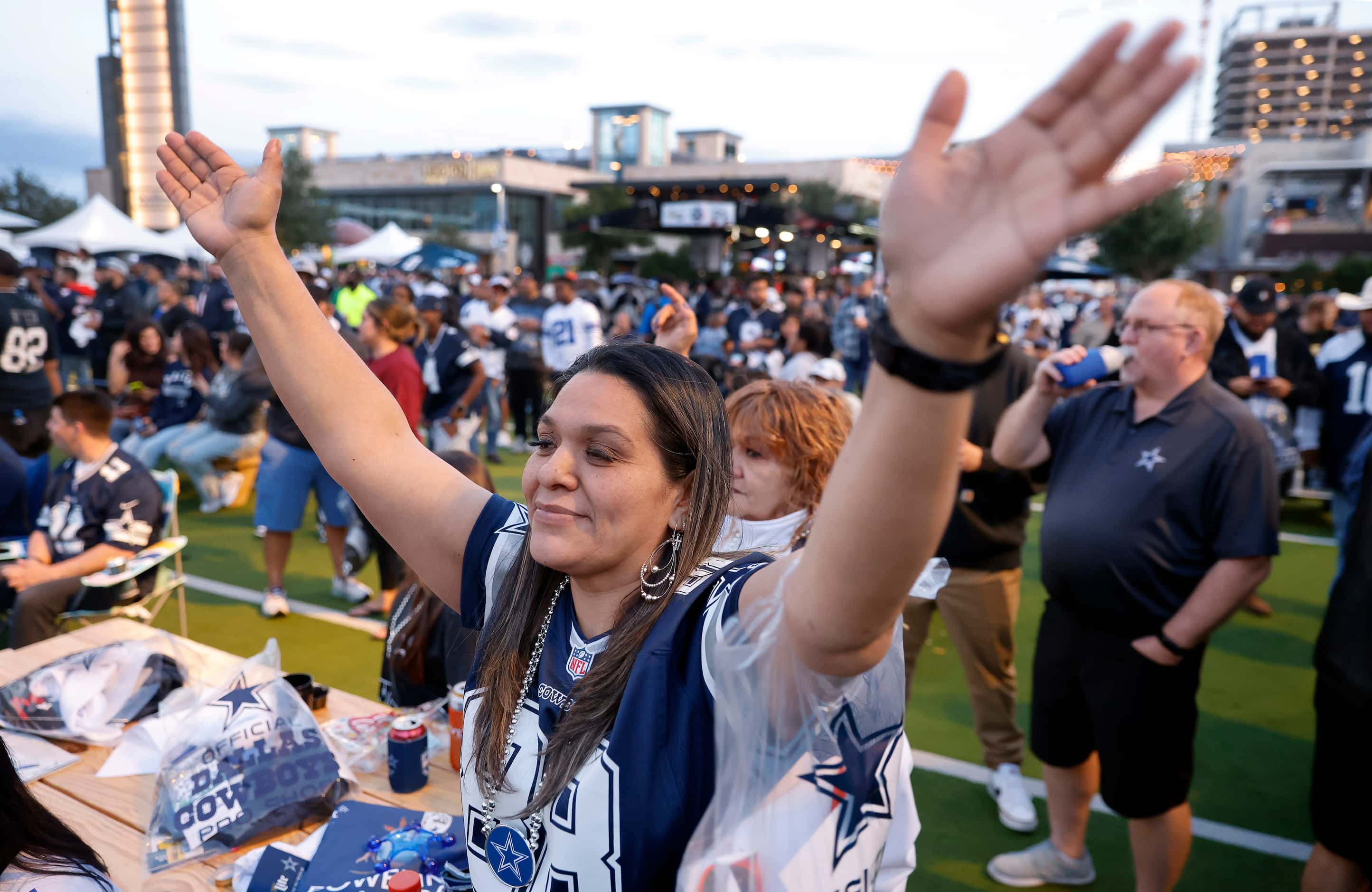 Dallas Cowboys fan Estella Ruiz of Mansfield dances to the music of a live band playing...
