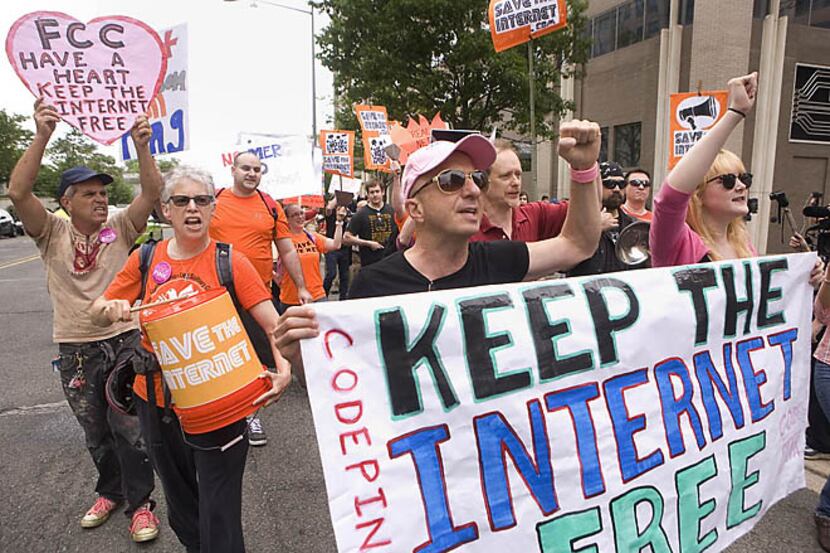 Demonstrators march against proposed changes to net neutrality regulations on May 15 outside...