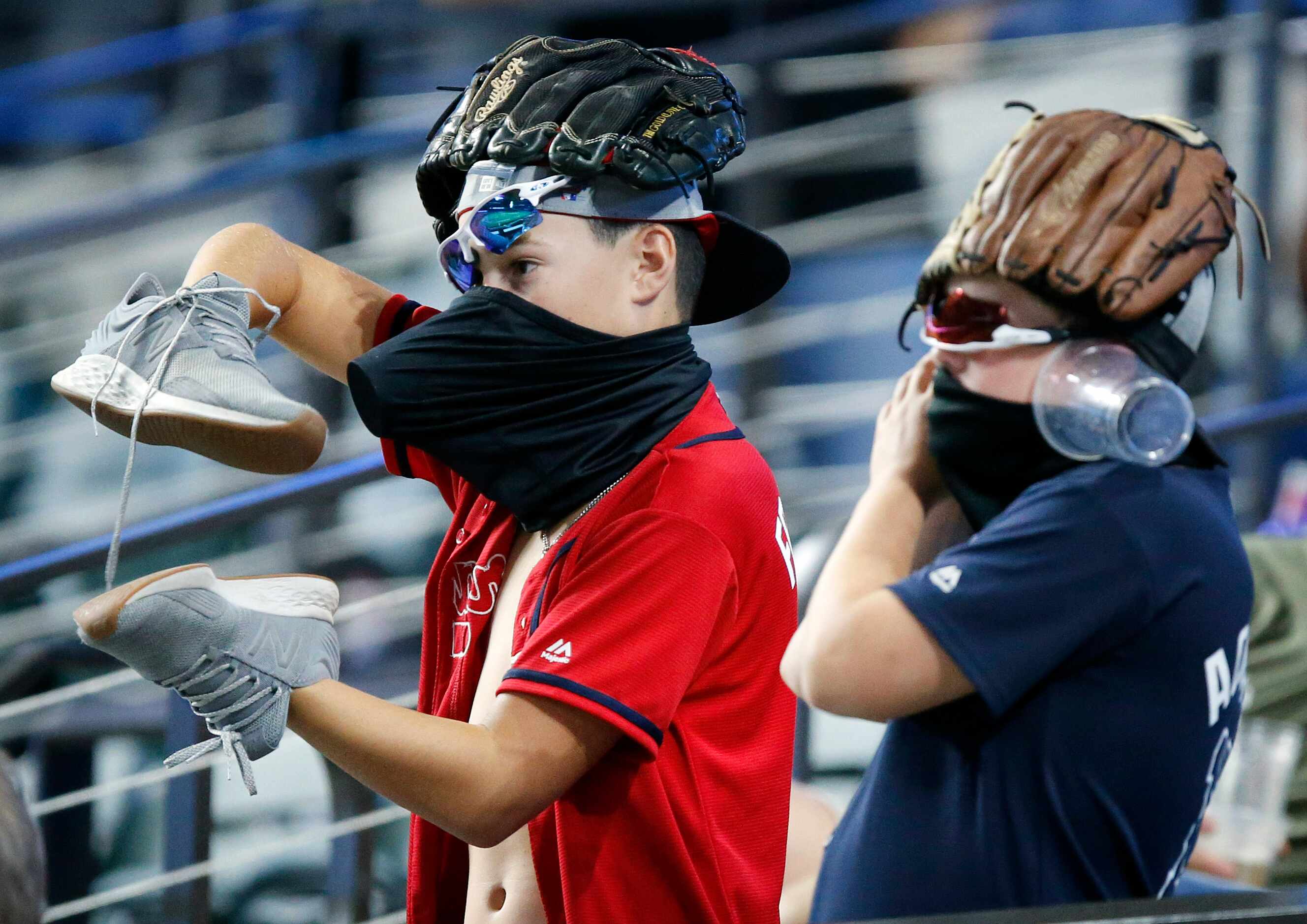 A pie of young Atlanta Braves fans try to rally their team during the ninth inning in Game 3...