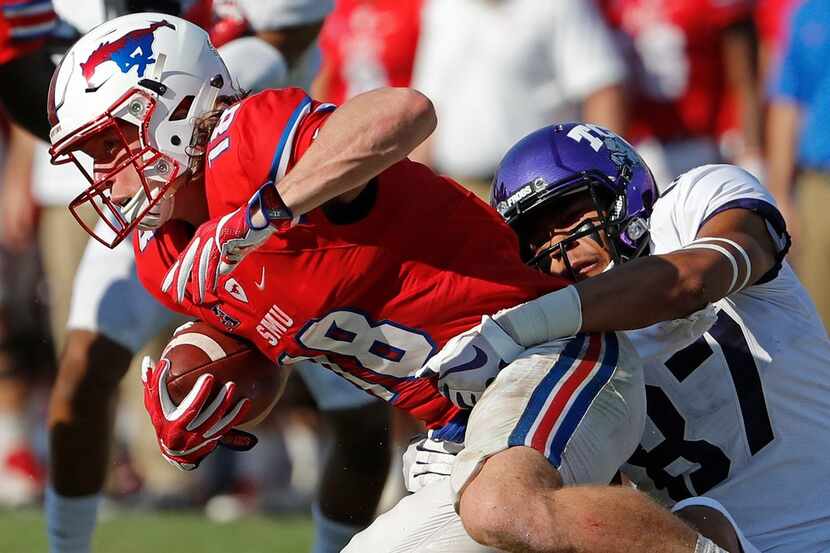 Southern Methodist Mustangs quarterback Ben Hicks (8) goes down in teh third quarter on a...