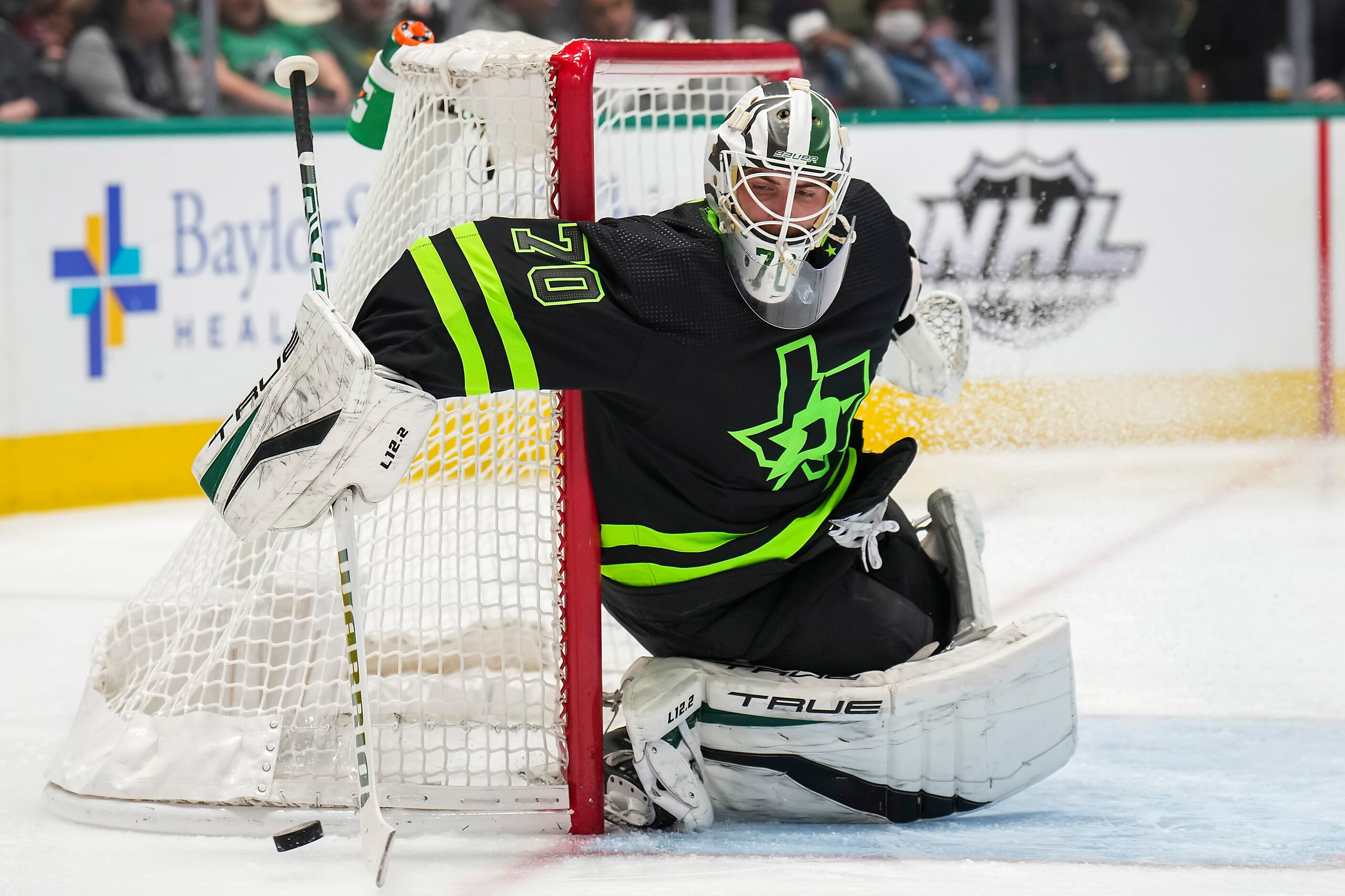 Dallas Stars goaltender Braden Holtby sweeps the puck away from his net during the second...