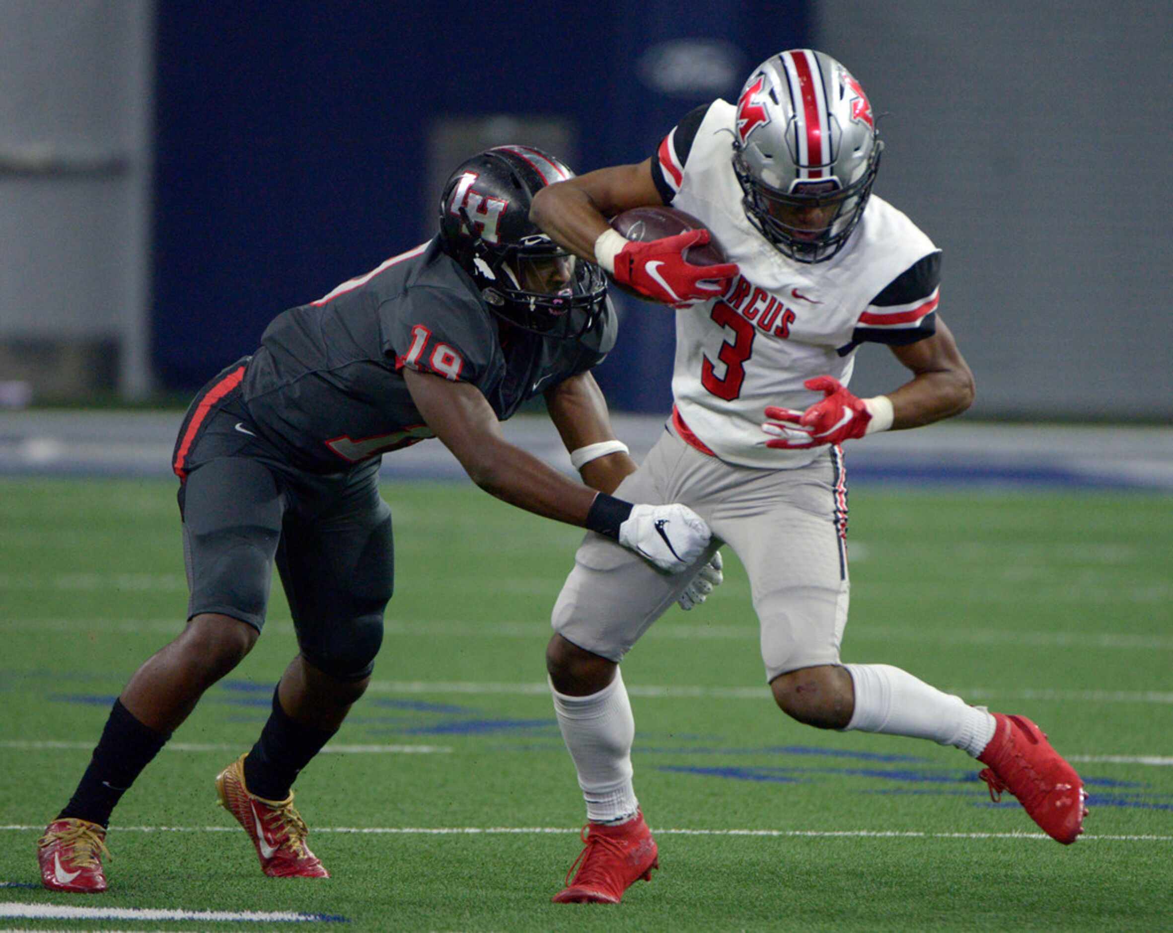 Flower Mound Marcus' Jaden Robinson (3) is tackled by Lake Highlands' Jason Daniels (19) in...