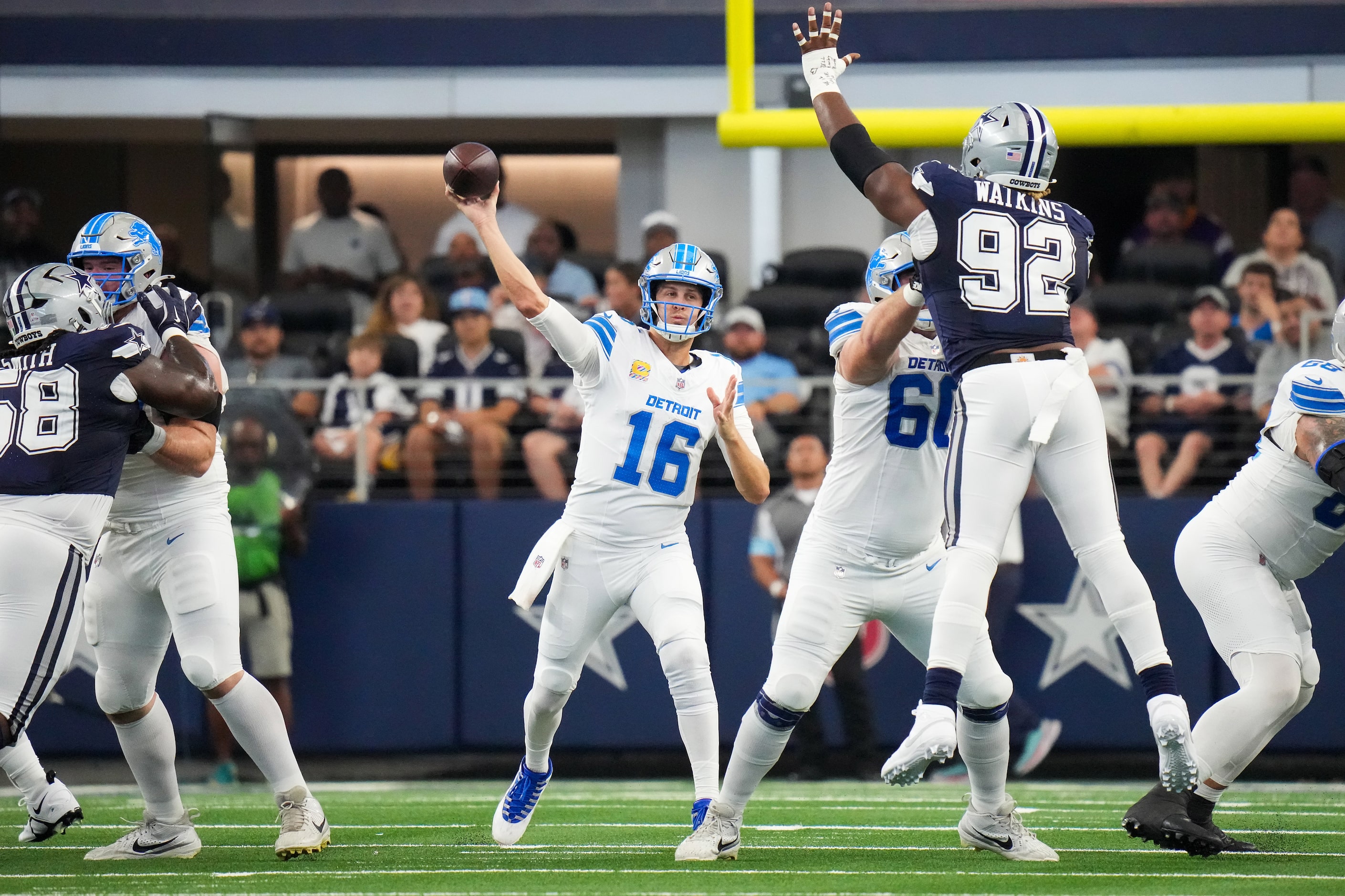 Detroit Lions quarterback Jared Goff (16) throws a pass over Dallas Cowboys defensive end...