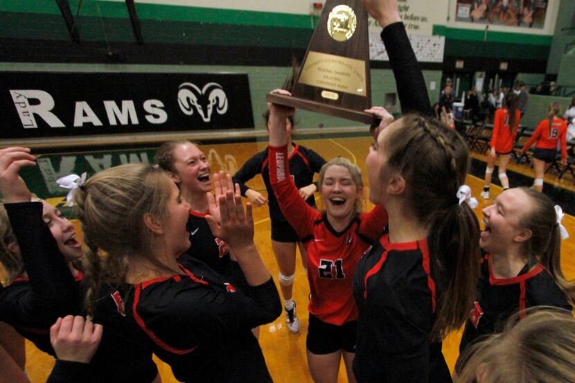 Lovejoy senior Michelle Foster (21) raises the trophy following a four-set victory over...
