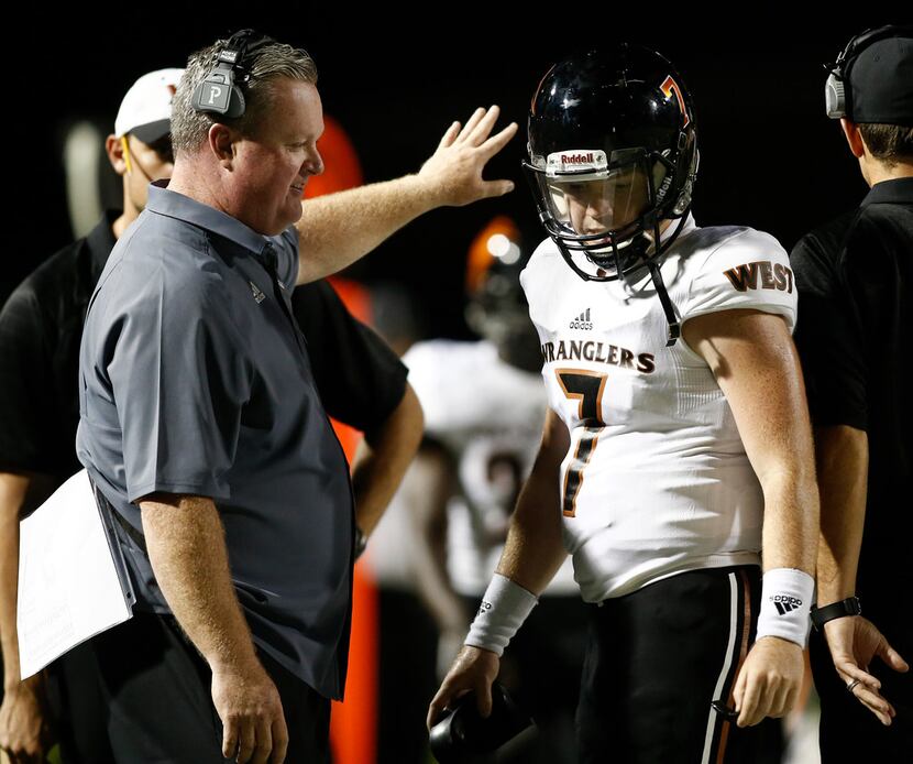 West Mesquite head coach Jeff Neill talks to his son, quarterback Connor Neill, in the first...